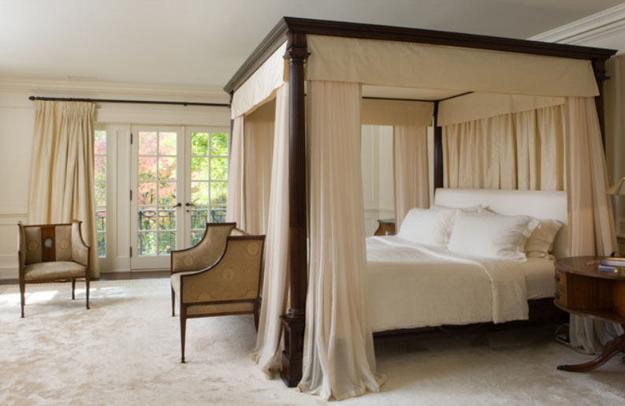 Wooden bed with light canopy curtains