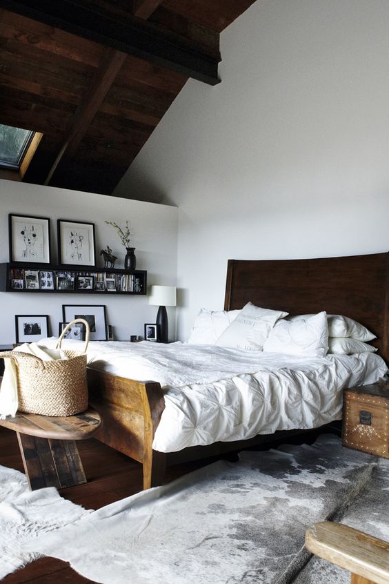 Beautiful eclectic bedroom with traditional dark wooden furniture and white paint and decoration.
