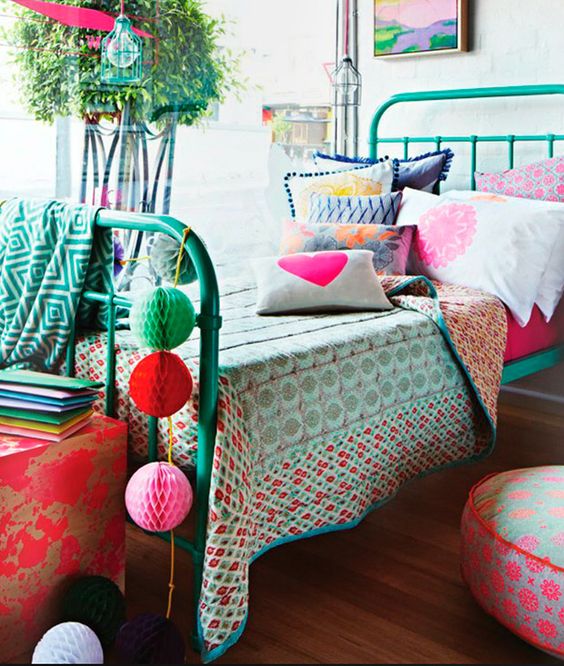 Eclectic girls bedroom with turquoise iron bed and colorful accessories