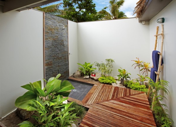 Relaxing outdoor shower area with plants