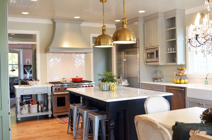 gray island kitchen with brass fixtures