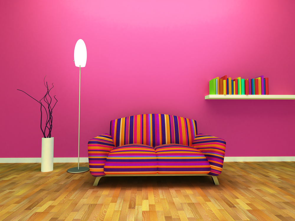 pink wall room with multi color couch
