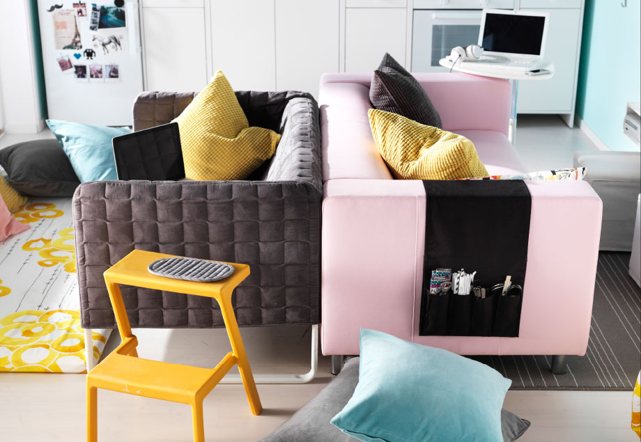 A gray and a pink sofa placed back-to-back
