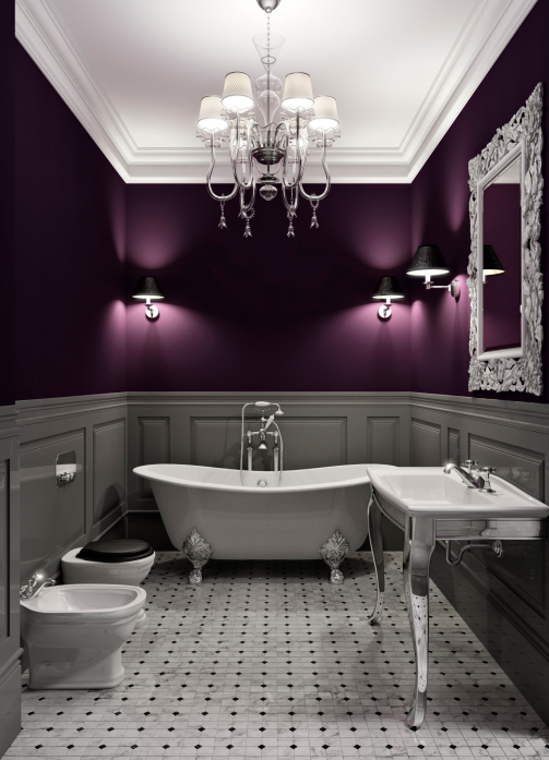 Elegant white and purple bathroom with claw tub and chandelier