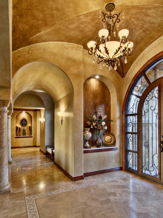 Beautiful tuscan entry way with huge art niche gorgeous lighting