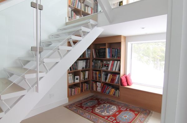 Stunning white bookcase under the stairs