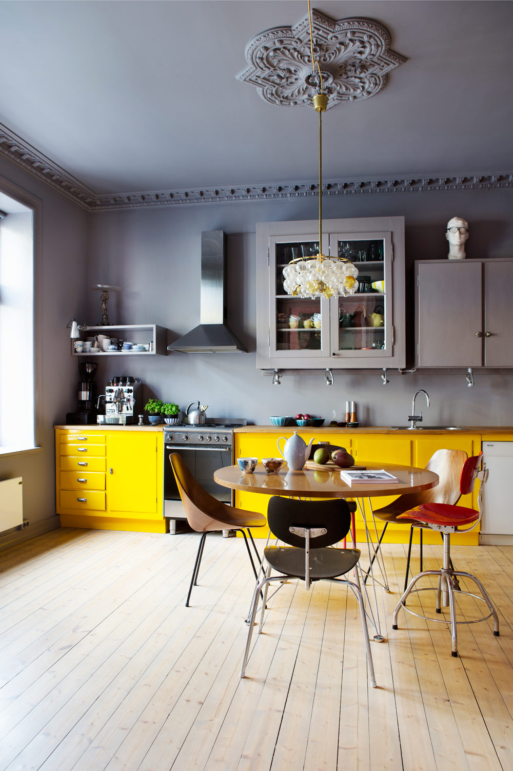 Colorful Kitchen With Yellow Cabinet Against Gray Walls