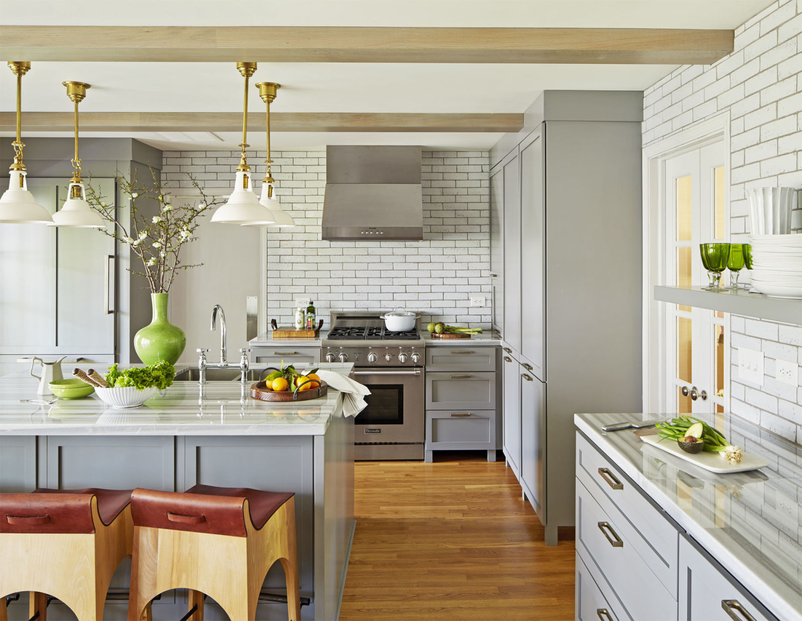 Kitchen With Beige Hardwood Flooring & White Wall