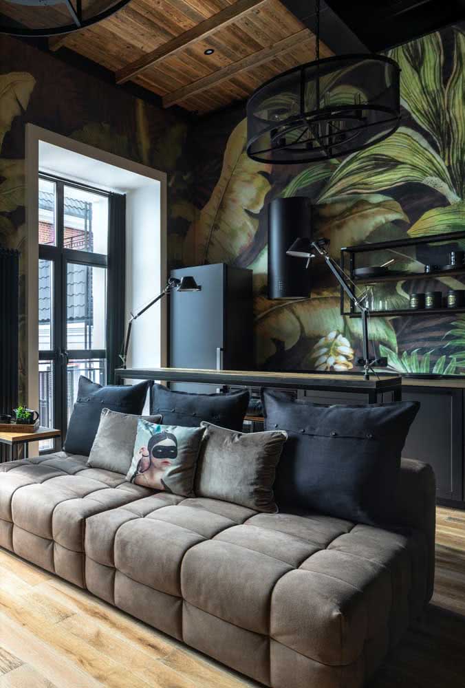 The integrated and modern room brought a brown three-seater sofa and black cushions to match.