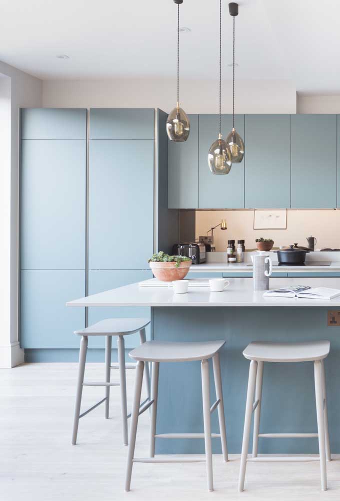 14. The soft shade of blue marks this other small kitchen with custom cabinets and a large counter.
