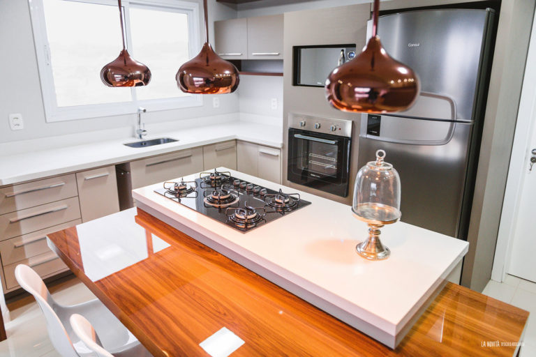 16. Central island with cooktop and copper chandeliers