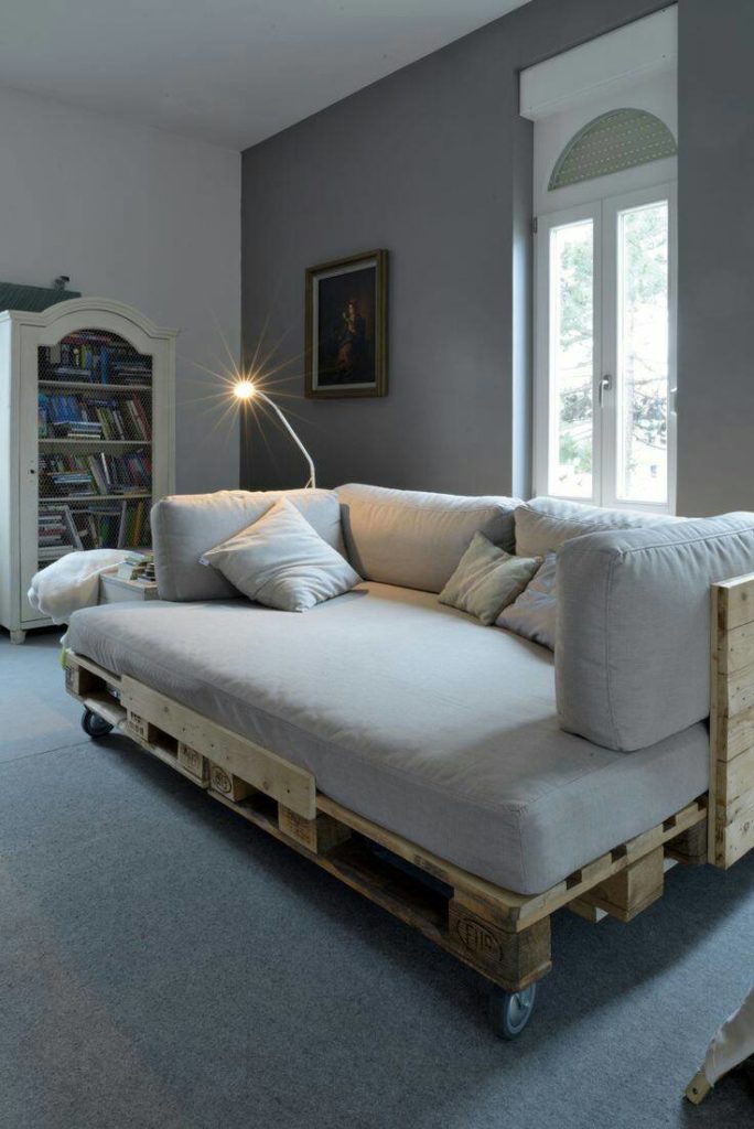 16. Large pallet sofa model with light can make the place much more intimate