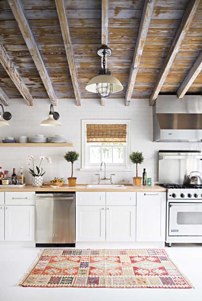 20. Rustic white kitchen with emphasis on the use of patina on the ceiling.