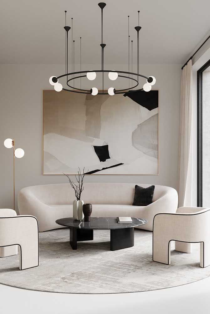 34 - Round modern chandelier accompanying the shape of the living room furniture in perfect harmony