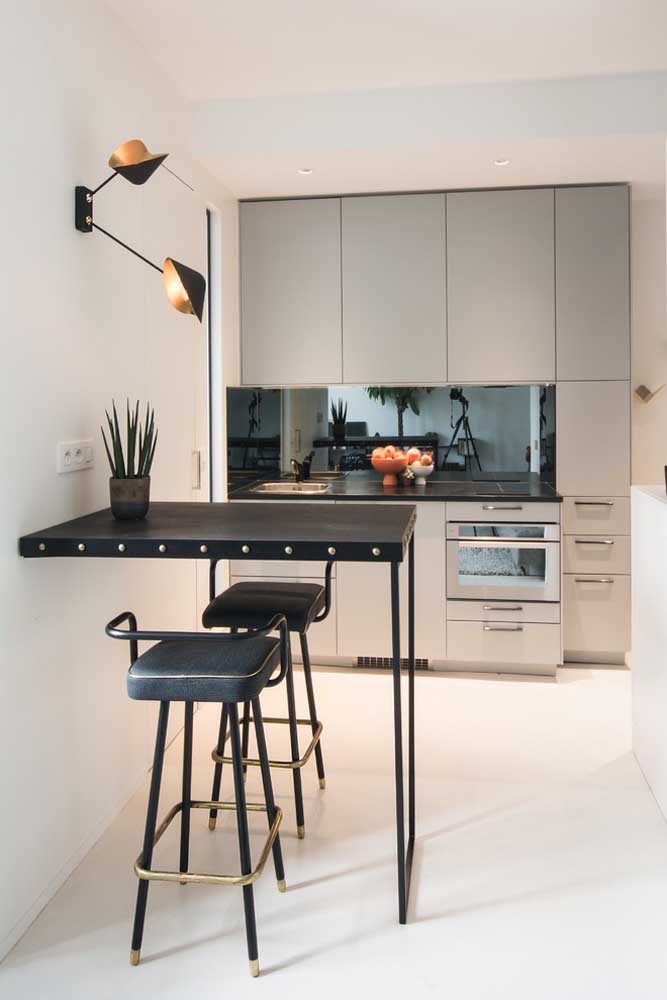 37. In this small American kitchen, the furniture fits into a single wall; highlight the stylish iron counter.
