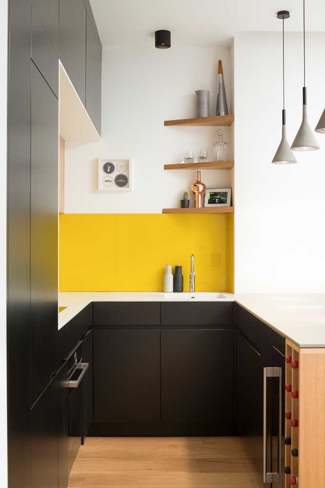 39. This small, planned American kitchen was perfect with the wooden angles and the yellow stripe on the wall to contrast with the black furniture.