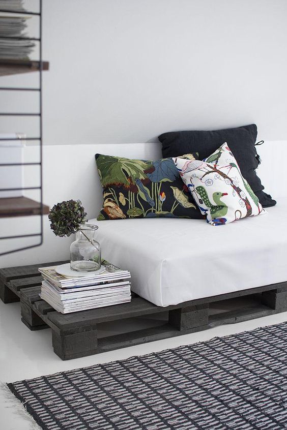 42. Simple pallet sofa with dark gray paint and white mattress
