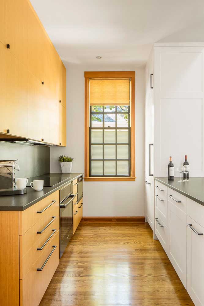 43. Small hallway-style kitchen with custom-made furniture on both sides of the room.