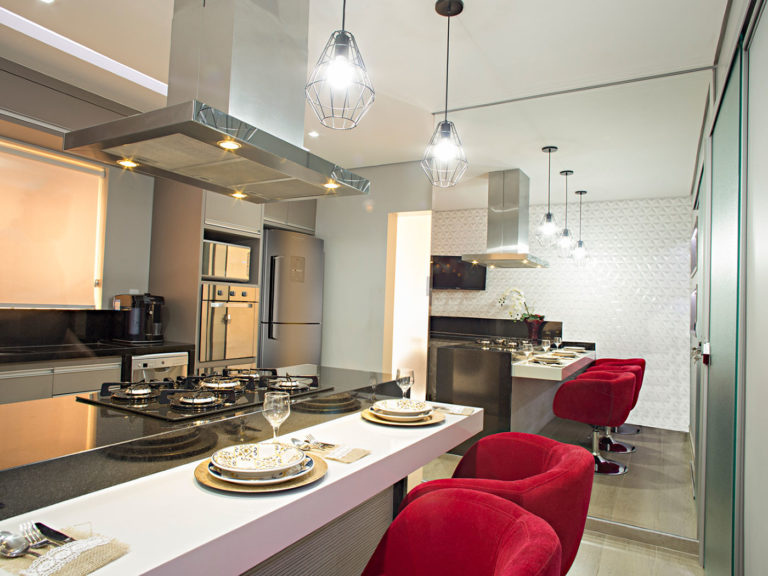 49. Kitchen with central island cooktop and red chairs