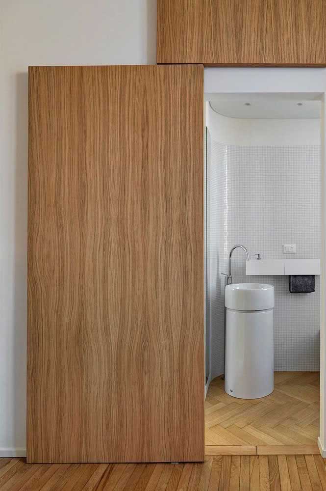 02 - Sliding door to the modern bathroom. The wood provides a clean and neutral environment.
