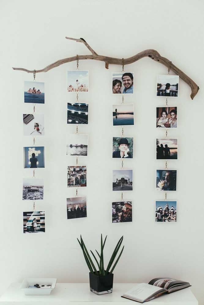 01. To make this photo panel, just take a sturdy branch from a tree, hang some chains and fix the photos.